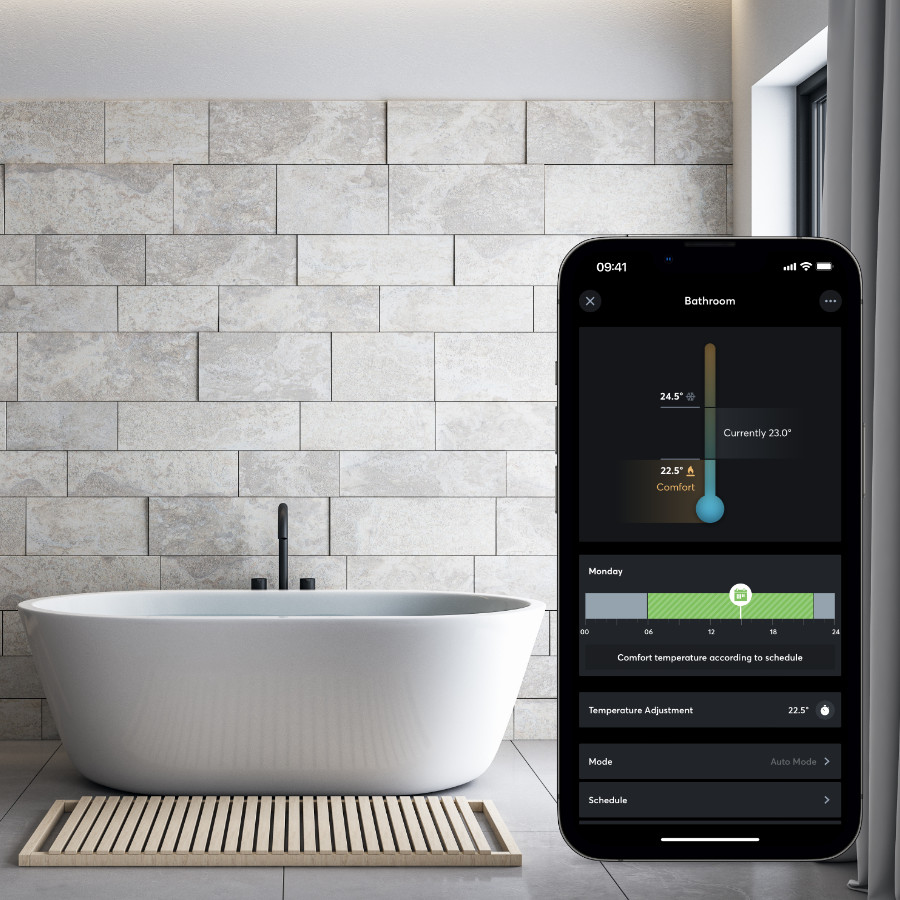 Home automation heating controls on mobile next to freestanding bath