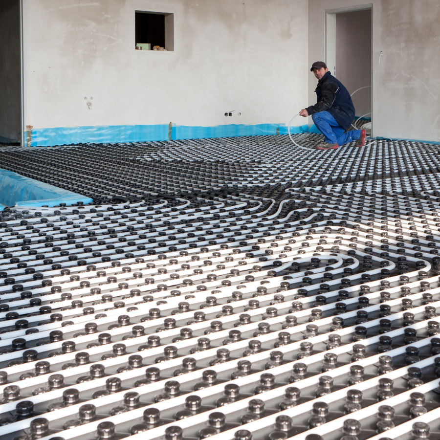 Man installing Aura Energy Services underfloor-heating system